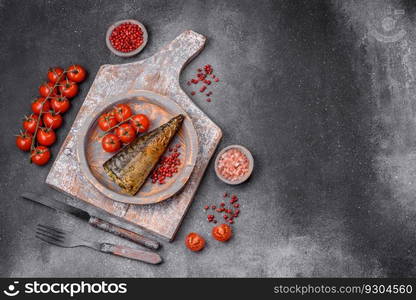 Delicious grilled mackerel with salt, spices and herbs on a textured concrete background