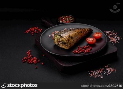 Delicious grilled mackerel with salt, spices and herbs on a textured concrete background