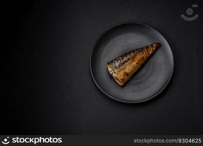 Delicious grilled mackerel with salt, spices and herbs on a textured concrete background