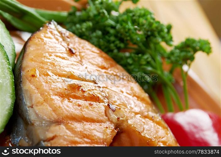 delicious grilled salmon steak with vegetables . Shallow depth-of-field