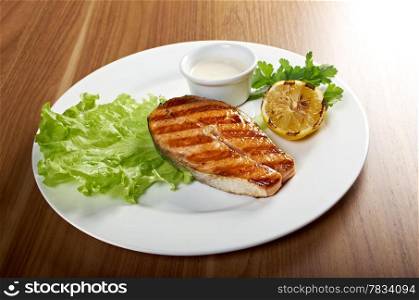delicious grilled salmon steak with vegetables . Shallow depth-of-field