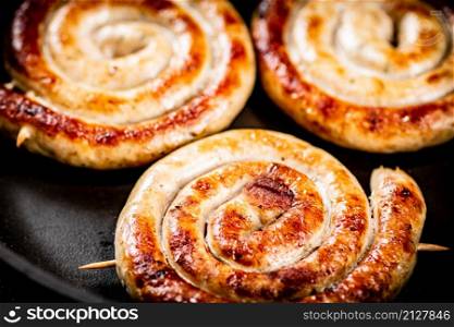 Delicious grilled sausages on a skewer. High quality photo. Delicious grilled sausages on a skewer.