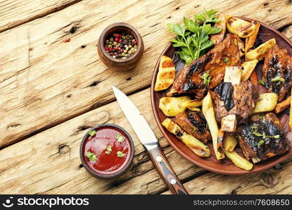 Delicious grilled veal ribs, fried beef ribs.BBQ grilled ribs. Roasted veal rib and fried potato