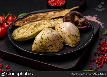 Delicious grilled vegetables zucchini, eggplant, peppers and mushrooms with salt, spices and herbs on a dark concrete background