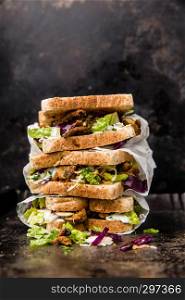 delicious gyros sandwich in paper bag with salad and tzatziki