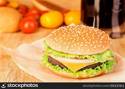 Delicious hamburger on brown paper on a wooden tabletop