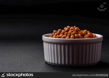 Delicious healthy canned lentils in a ceramic ribbed white bowl on a dark concrete background