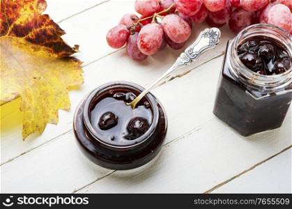 Delicious homemade autumn grape jam on white background.Autumn dessert.. Homemade berry jam
