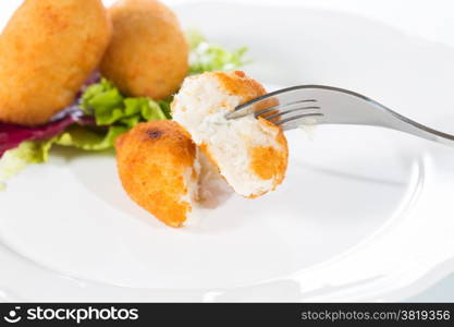 Delicious homemade croquettes on your plate with salad