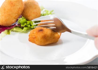 Delicious homemade croquettes on your plate with salad