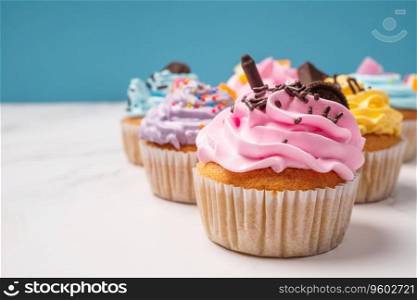 Delicious homemade cupcakes with Colorful cream and topping with candy and Chocolate Cookies. Homemade autumn holiday dessert