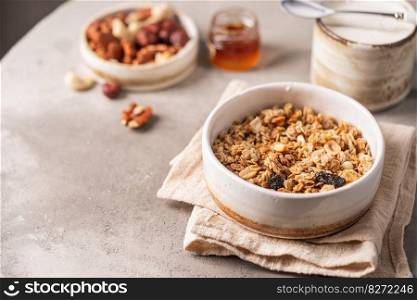 Delicious homemade granola in a bowl on gray background. Breakfast. Healthy food sweet dessert snack. Diet nutrition concept. Vegetarian food.. Delicious homemade granola