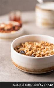 Delicious homemade granola in a bowl on gray background. Breakfast. Healthy food sweet dessert snack. Diet nutrition concept. Vegetarian food.. Delicious homemade granola