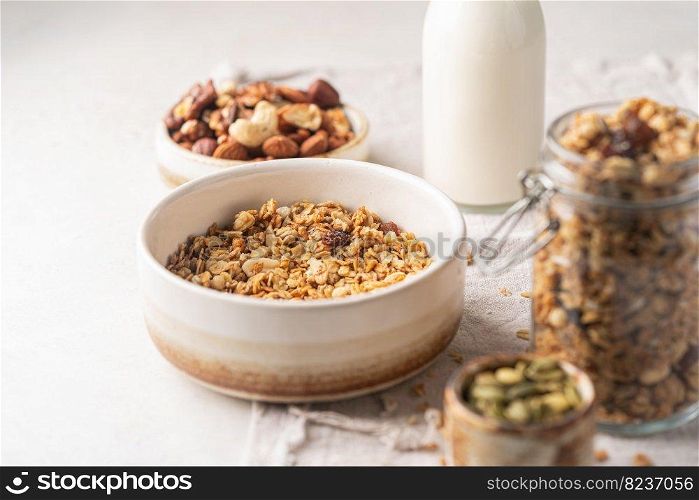 Delicious homemade granola in a bowl on white background. Breakfast. Healthy food sweet dessert snack. Diet nutrition concept. Vegetarian food.. Delicious homemade granola