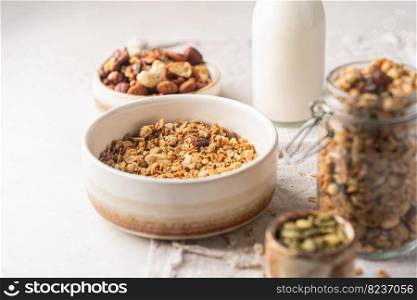Delicious homemade granola in a bowl on white background. Breakfast. Healthy food sweet dessert snack. Diet nutrition concept. Vegetarian food.. Delicious homemade granola
