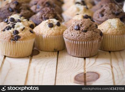 delicious homemade muffins over wooden board selective focus