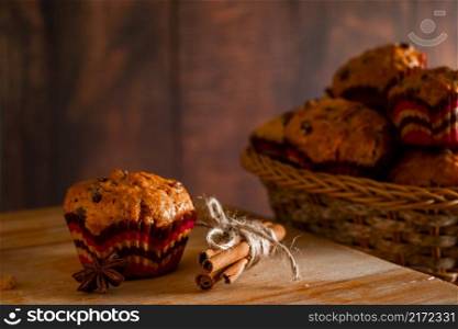 Delicious homemade muffins with raisins. Christmas baking on a wooden background.. Homemade muffins with raisins. Christmas baking on a wooden background.