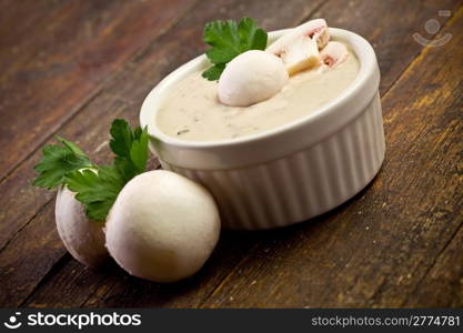 delicious homemade mushroom sauce on wooden table with parsley