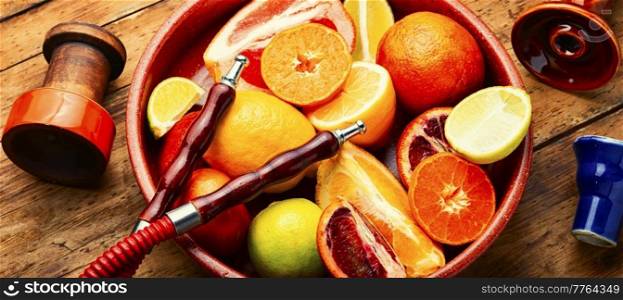 Delicious hookah with orange, lime, lemon and grapefruit. Relaxation citrus hookah tobacco.. Smoking hookah with citrus fruits.