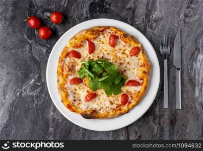 Delicious hot homemade pizza on the stone table background. Traditional Italian pizza
