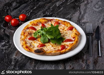 Delicious hot homemade pizza on the stone table background. Traditional Italian pizza