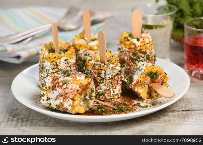 Delicious Indian of corn cob, also called Bhutta, flavored with butter, spices garam masala and cilantro