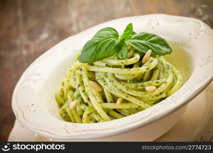 Delicious italian pasta with ligurian pesto and pine nuts