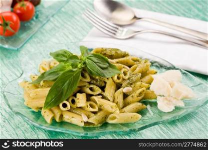 Delicious italian pasta with ligurian pesto inside glass dishware