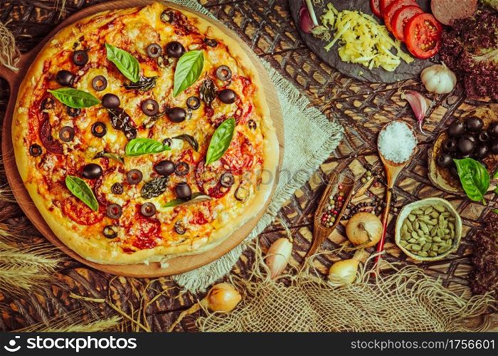 Delicious italian pizza. Tasty fresh italian pizza. Delicious taste margarita pizza. Traditional pizza with cheese, tomatoes, black olives, basil.