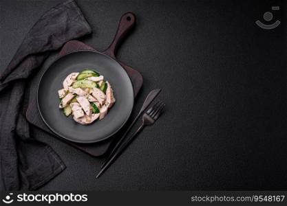 Delicious juicy fresh salad of cucumbers and grilled chicken slices, with french mustard, salt and spices on a dark concrete background