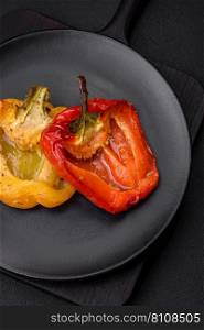 Delicious juicy grilled peppers with spices and herbs on a dark concrete background