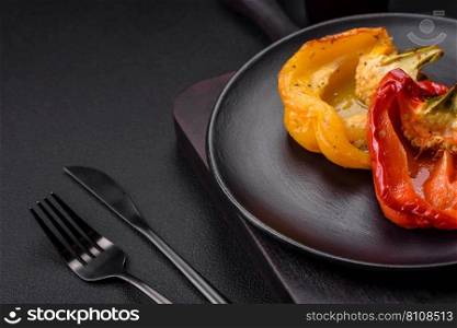 Delicious juicy grilled peppers with spices and herbs on a dark concrete background