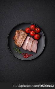 Delicious juicy pork or beef steak cooked on the grill with salt and spices on a textured concrete background