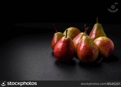Delicious juicy sweet green pear with red side on dark textured concrete background