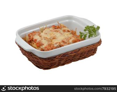Delicious lasagna in wicker basket on an isolated background. Delicious lasagna in wicker basket