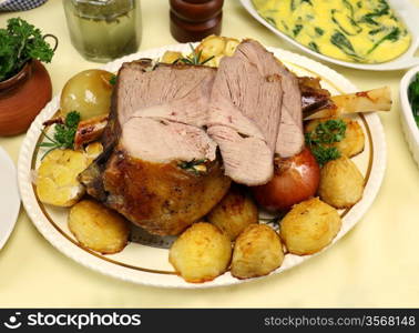 Delicious leg of lamb carved with vegetables ready to serve.