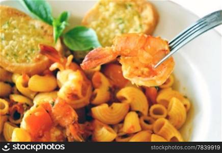 Delicious macaroni with cheese and tomato, shrimp on fork