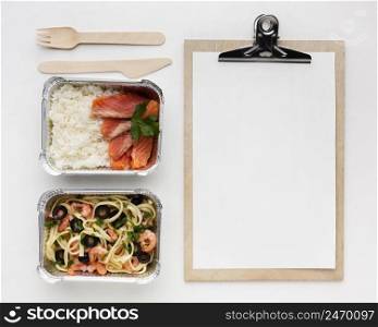 delicious meal arrangement with empty clipboard