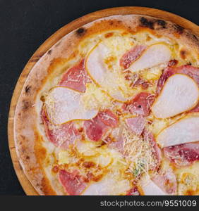 Delicious meat pizza with salami, ham and cheese