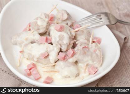 Delicious meat rolls and ham cooked in white wine