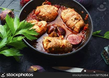 Delicious meat sausage with autumn figs in iron cast pan. Meat fried rolls.
