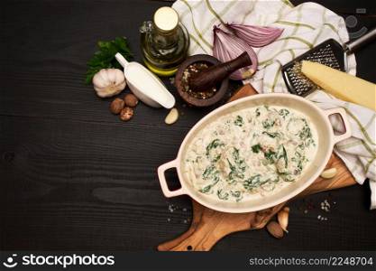 Delicious meatballs with spinach in a creamy sauce in baking dish. High quality photo. Delicious meatballs with spinach in a creamy sauce in baking dish