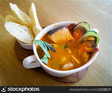 Delicious mediterranean seafood soup on wooden table