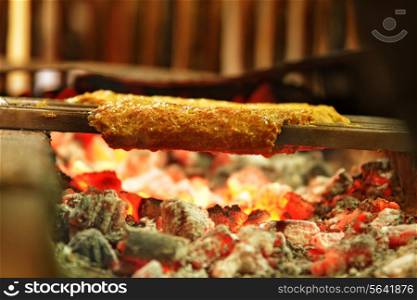 Delicious minced meat being barbecued