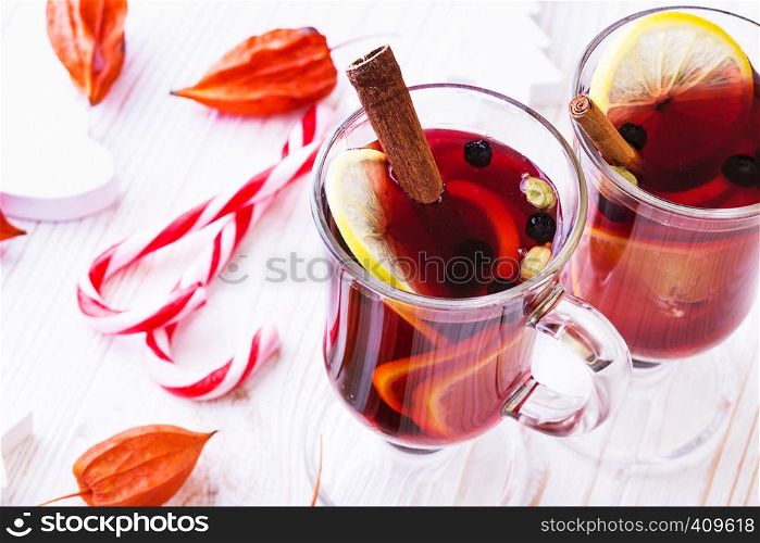 delicious mulled wine with cinnamon, lemon, cardamom poured over glasses. Christmas