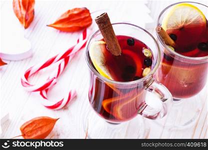 delicious mulled wine with cinnamon, lemon, cardamom poured over glasses. Christmas