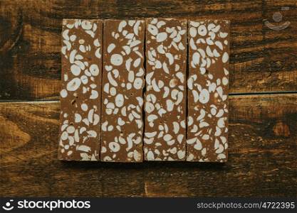 Delicious nougat typical sweet Christmas on a rustic wooden background