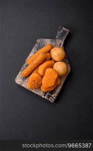 Delicious nuggets, sticks and balls of mozzarella and parmesan cheese with salt and spices. Fast food, unhealthy food