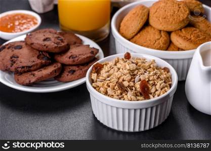 Delicious nutritious hea<hy breakfast with granola, eggs, oat cookies, milk and jam. Hea<hy eating at the beginning of the day. Delicious nutritious hea<hy breakfast with granola, eggs, oat cookies, milk and jam