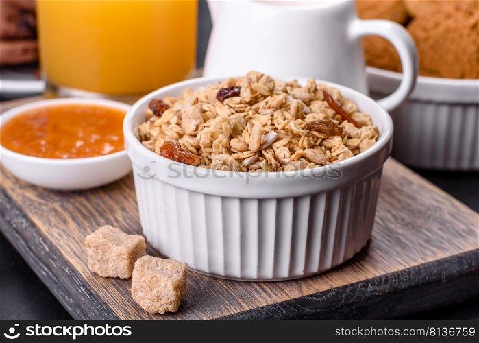 Delicious nutritious healthy breakfast with granola, eggs, oat cookies, milk and jam. Healthy eating at the beginning of the day. Delicious nutritious healthy breakfast with granola, eggs, oat cookies, milk and jam